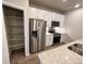 Modern kitchen with white cabinets, stainless steel appliances, and pantry at 8428 Galvani Trl # D, Littleton, CO 80129