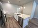 Close-up of the kitchen island with stainless steel sink and granite countertop at 8428 Galvani Trl # D, Littleton, CO 80129