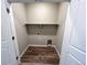 Neat laundry space features wood look floors and shelf for extra storage opportunities at 8428 Galvani Trl # D, Littleton, CO 80129