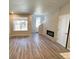 Inviting living room featuring a fireplace, large windows, and wood-look floors at 8428 Galvani Trl # D, Littleton, CO 80129