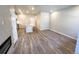Open-concept living space with fireplace, kitchen island, and wood-look floors at 8428 Galvani Trl # D, Littleton, CO 80129