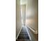 Carpeted staircase with handrail leading to the upper level at 8428 Galvani Trl # D, Littleton, CO 80129