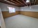 Unfinished basement with carpeting, wood paneling, and a single window at 22967 E Mineral Pl, Aurora, CO 80016