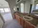 Bathroom featuring a double sink vanity with wood cabinetry and a large mirror at 22967 E Mineral Pl, Aurora, CO 80016