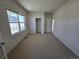 Bright bedroom with a window, closet, and neutral carpeting for a cozy feel at 22967 E Mineral Pl, Aurora, CO 80016