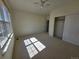 Bright bedroom featuring carpeted floors, a ceiling fan, a closet, and a large window for natural light at 22967 E Mineral Pl, Aurora, CO 80016