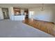 Open-concept living space combining hardwood and carpeted areas, next to the kitchen at 22967 E Mineral Pl, Aurora, CO 80016