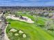 Scenic aerial view of the golf course featuring sand traps and pond, complemented by the surrounding residential community at 2685 S Dayton Way # 145, Denver, CO 80231