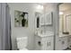 Clean bathroom with a modern toilet, vanity, mirror and updated lighting at 2685 S Dayton Way # 145, Denver, CO 80231