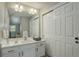 Bathroom vanity with generous mirror and lighting plus convenient access to storage at 2685 S Dayton Way # 145, Denver, CO 80231