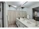 Stylish bathroom features a vanity, a neutral color palette, and a framed mirror at 2685 S Dayton Way # 145, Denver, CO 80231