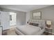 Comfortable bedroom featuring a soft bed, bedside tables, and a glimpse into the en-suite bathroom at 2685 S Dayton Way # 145, Denver, CO 80231