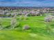 Picturesque aerial perspective of the golf course integrated with residential properties and serene ponds at 2685 S Dayton Way # 145, Denver, CO 80231