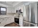 Clean kitchen featuring stainless appliances, abundant white cabinetry, and a modern aesthetic at 2685 S Dayton Way # 145, Denver, CO 80231