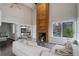 Bright living room with vaulted ceiling, brick fireplace, and view to outdoor patio at 2685 S Dayton Way # 145, Denver, CO 80231