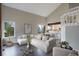 Bright, open-concept living room featuring high ceilings, wood floors, and access to the kitchen at 2685 S Dayton Way # 145, Denver, CO 80231