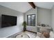 Bright living room features a vaulted ceiling, wooden beam, and a large window, and modern decor at 2685 S Dayton Way # 145, Denver, CO 80231