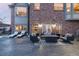 Inviting backyard patio with lounge seating, an outdoor fireplace and manicured landscaping at 27319 E Nova Cir, Aurora, CO 80016