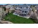 Expansive backyard featuring a patio, lush lawn, and a charming exterior with a covered deck at 27319 E Nova Cir, Aurora, CO 80016