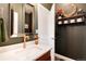 Stylish half-bathroom showcasing a modern vanity, updated fixtures, and unique decor for a luxurious touch at 27319 E Nova Cir, Aurora, CO 80016