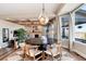 Elegant dining room with a modern light fixture, hardwood floors, and large windows offering scenic views at 27319 E Nova Cir, Aurora, CO 80016