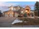 Beautiful brick two-story home boasting a three-car garage and inviting curb appeal with professional landscaping at 27319 E Nova Cir, Aurora, CO 80016