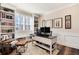 Home office with built-in shelving and hardwood floors at 27319 E Nova Cir, Aurora, CO 80016