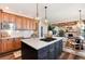 Open concept kitchen features an island with cooktop and breakfast bar at 27319 E Nova Cir, Aurora, CO 80016