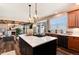 Open-concept kitchen featuring a center island, modern appliances, and seamless transition to the dining area at 27319 E Nova Cir, Aurora, CO 80016