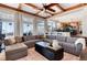 Open concept living room with a large sectional sofa, offering views into the kitchen and dining areas at 27319 E Nova Cir, Aurora, CO 80016