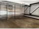 Spacious basement featuring gray concrete floors and translucent sliding panel doors with black trim at 1111 Osage St # 7, Denver, CO 80204