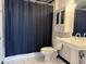 Bathroom with a pedestal sink, tiled floors, and a cabinet for storage at 1111 Osage St # 7, Denver, CO 80204