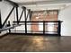Interior view featuring brick wall, ceiling fan and exposed ductwork behind black metal railing at 1111 Osage St # 7, Denver, CO 80204