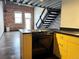 Modern kitchen features light wood cabinets and black countertops with breakfast bar at 1111 Osage St # 7, Denver, CO 80204