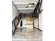 Open living space with metal stairs, hardwood floors, modern kitchen, and upstairs loft area at 1111 Osage St # 7, Denver, CO 80204