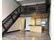 Open living space with metal stairs, hardwood floors, modern kitchen, and upstairs loft area at 1111 Osage St # 7, Denver, CO 80204