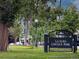 View of the La Alma Lincoln Park entrance surrounded by lush trees and green grass on a bright day at 1111 Osage St # 7, Denver, CO 80204