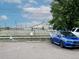 View of blue car parked on paved parking area and railroad tracks at 1111 Osage St # 7, Denver, CO 80204
