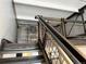 View of modern interior staircase with metal railings and open design, leading to a upper floor at 1111 Osage St # 7, Denver, CO 80204