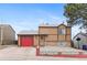 Inviting two-story home showcasing neutral siding, a red garage door, and easy-to-maintain rock landscaping at 3977 S Pitkin Way, Aurora, CO 80013