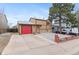 Charming two-story home featuring a red garage door, neutral siding, and mature landscaping for great curb appeal at 3977 S Pitkin Way, Aurora, CO 80013