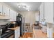 Functional kitchen with black appliances, ample counter space, and convenient built-in pantry shelving at 3977 S Pitkin Way, Aurora, CO 80013