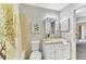 Well-lit bathroom featuring neutral tones, a vanity, and a shower with a decorative curtain at 5735 W Atlantic Pl # 101, Lakewood, CO 80227