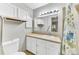 Neat bathroom with white cabinets, good lighting, and a shower with curtain at 5735 W Atlantic Pl # 101, Lakewood, CO 80227