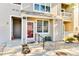 Inviting front entrance with well-maintained landscaping and a charming red door at 5735 W Atlantic Pl # 101, Lakewood, CO 80227