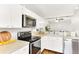 Well-equipped kitchen with stainless steel appliances and white cabinetry at 5735 W Atlantic Pl # 101, Lakewood, CO 80227
