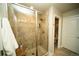 Modern bathroom shower featuring glass door, tiled walls, and shelving for toiletries at 359 Courtfield Way, Castle Pines, CO 80108