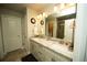 Bright bathroom featuring a double vanity with granite counters and modern lighting at 359 Courtfield Way, Castle Pines, CO 80108