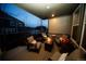 Cozy covered porch with comfortable seating and inviting fire pit at 359 Courtfield Way, Castle Pines, CO 80108