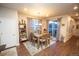 Bright dining area featuring wood table, decorative lighting fixture and large sliding glass doors to a deck at 359 Courtfield Way, Castle Pines, CO 80108